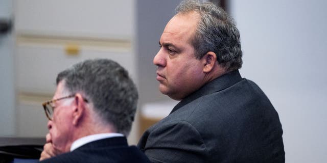 Defendant Bahram Hojreh, right, listens to opening statements with his attorney, John Barnett, during his trial in Orange County Superior Court in Santa Ana, CA