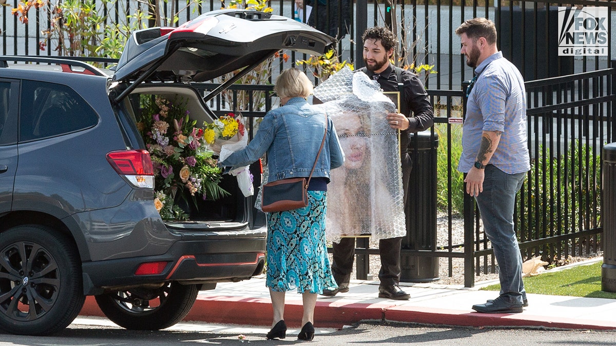 A photo of Rachel Morin is carried into the church for her funeral.
