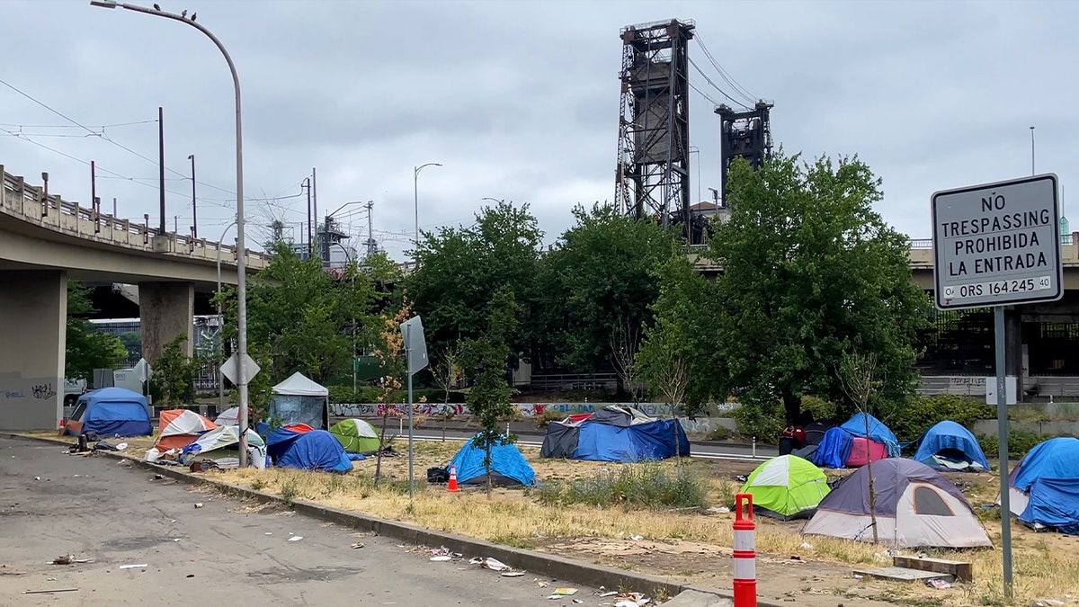 homeless tents in front of steel bridge in Portland, Oregon