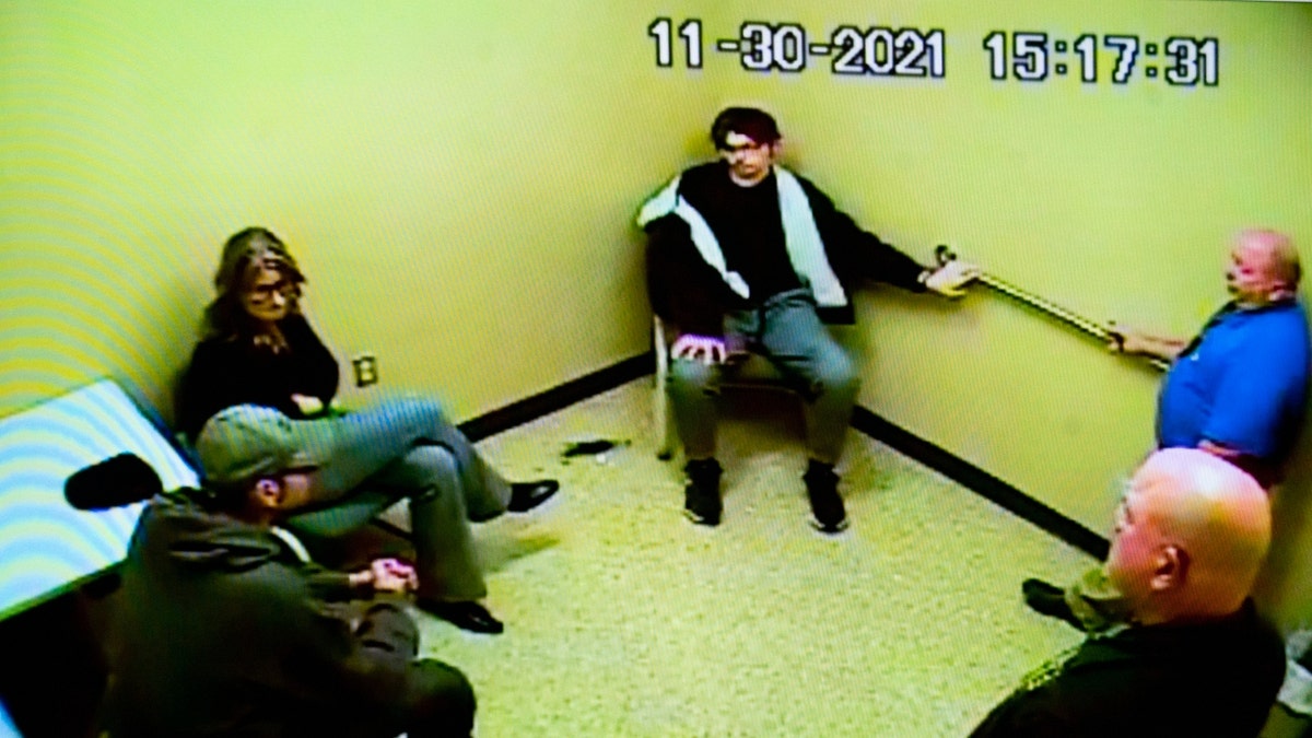 Police footage of James Crumbley, left, Jennifer Crumbley, center, and Ethan Crumbley in an interview room at the Oakland County Sheriff’s Department on Nov. 30, 2021, after Ethan shot and killed four students at Oxford High School, is displayed Monday, Jan. 29, 2024, in an Oakland County courtroom, in Pontiac, Mich., during the trial of Jennifer, who is charged with involuntary manslaughter.