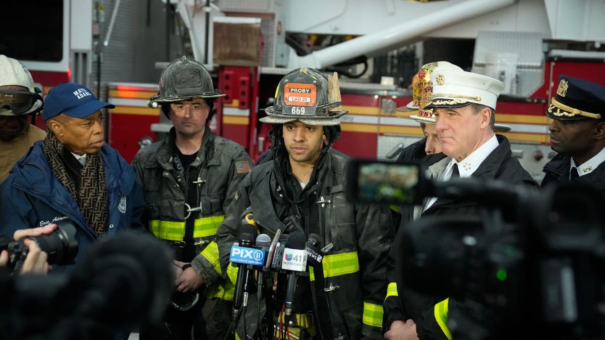 A firefighter speaks during a press conference with New York City Mayor Eric Adams