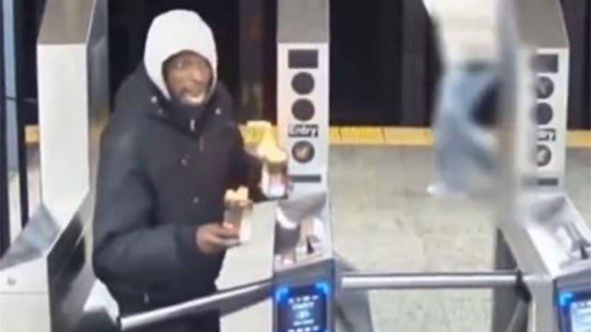 Man entering subway system with flaming cans in hands