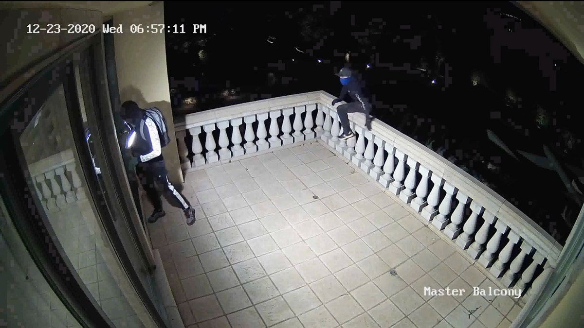 Thieves on a balcony breaking into house