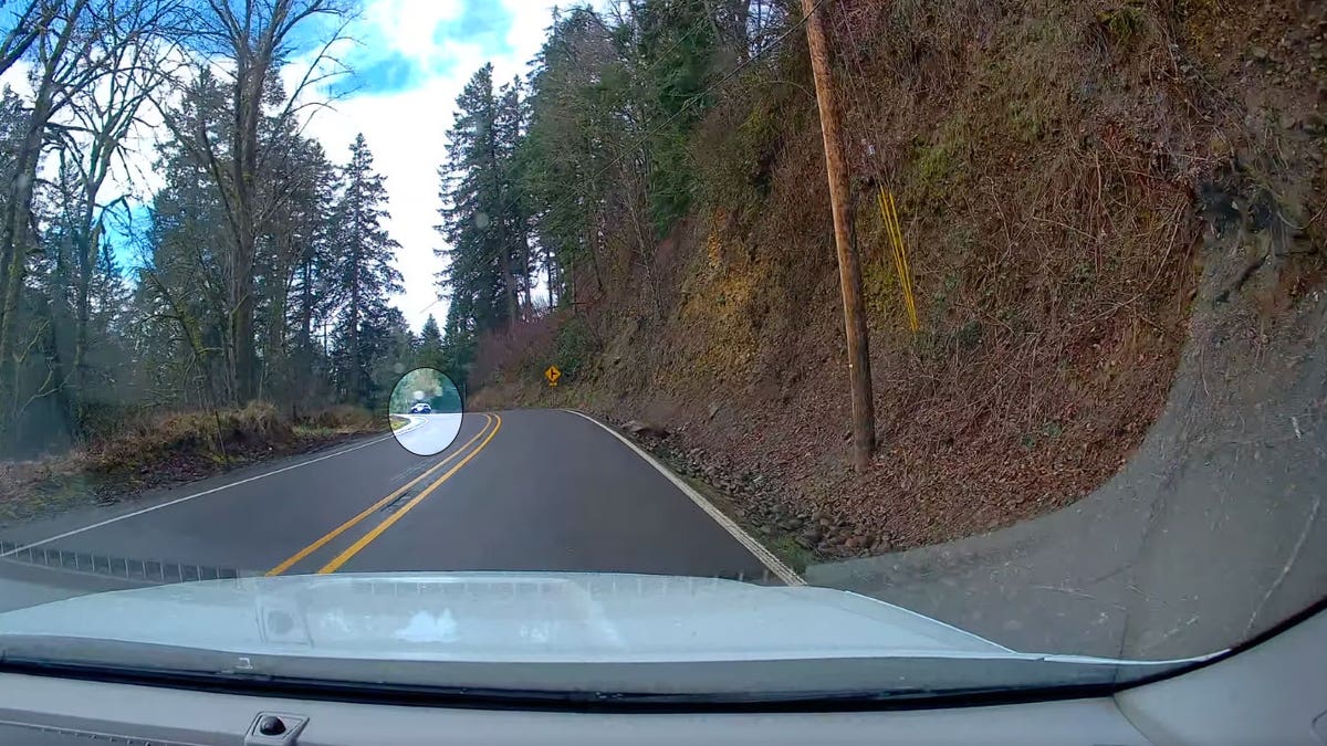 Car on Oregon window road towards trooper