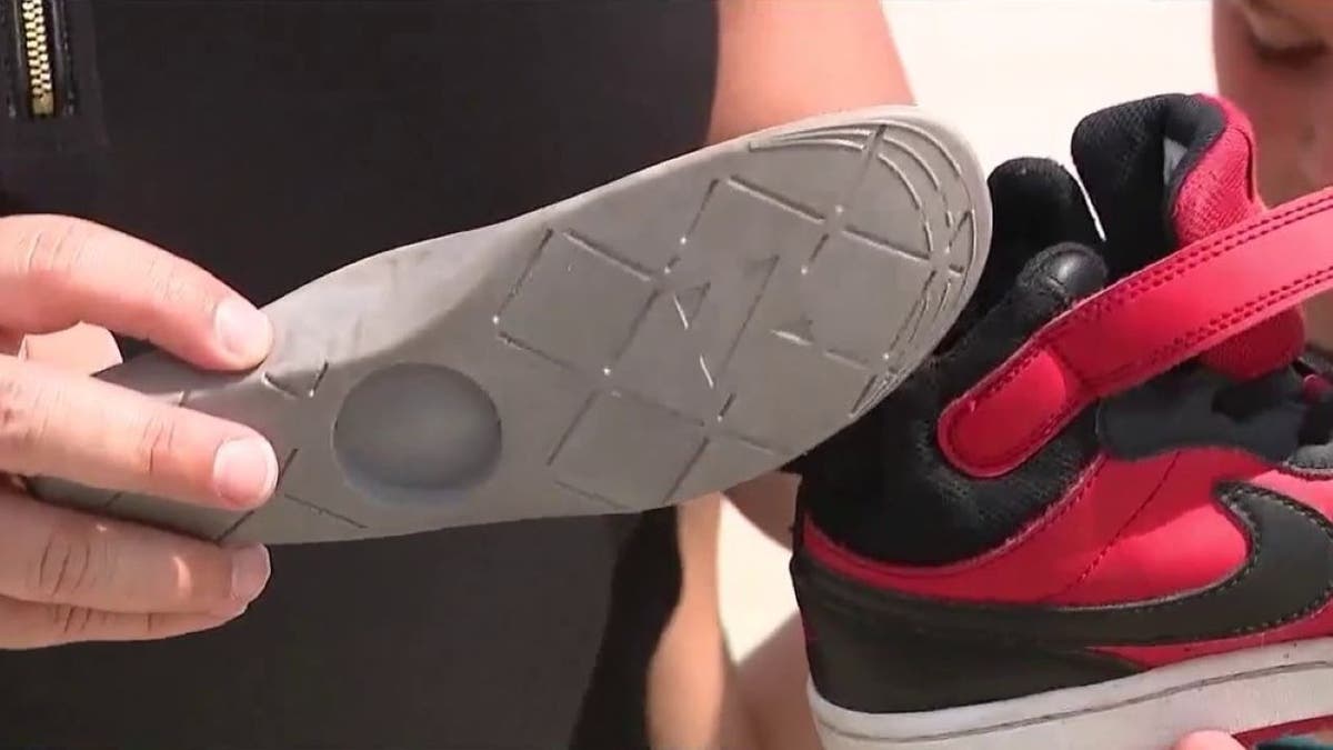 Jackie Giurleo showing the compartment in her son's shoe