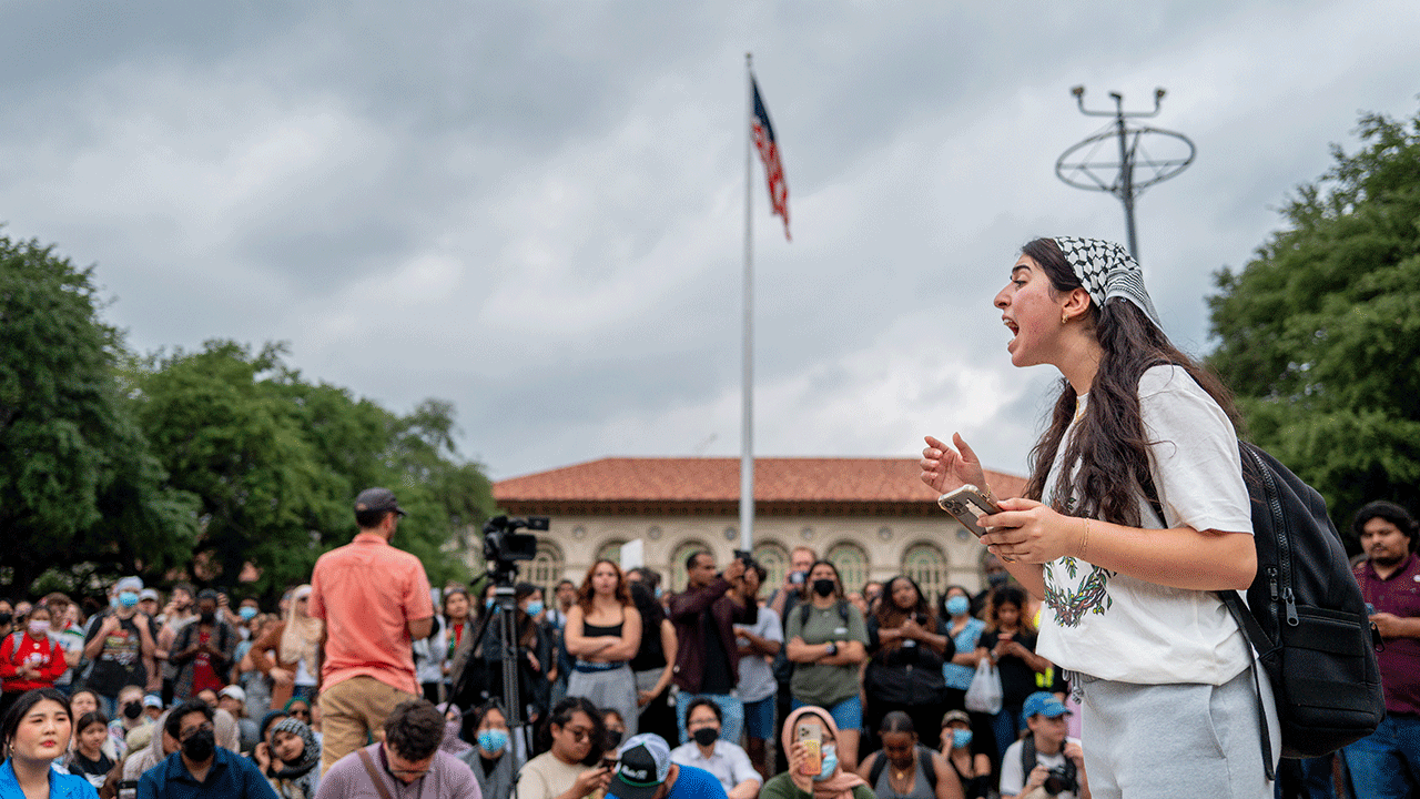 Student speaks to crowd of students at the University of Texas at Austin.